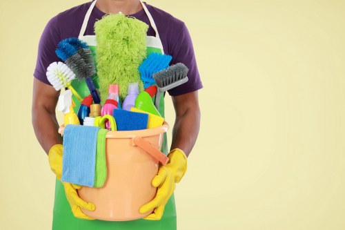 Professional domestic cleaner tidying a modern apartment in E1