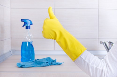 A cleaner maintaining a shared office space in E1